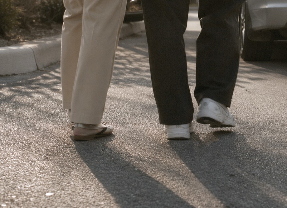 Peter walking a client to her car after her outpatient procedure